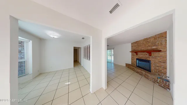 a view of an empty room with a fireplace