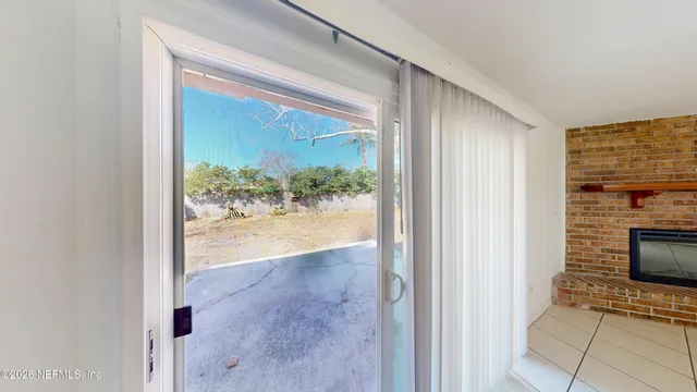 a view of a hallway with wooden floor and a living room