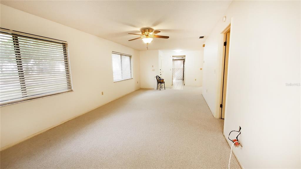 603 Baldwin Avenue, Unit B Safety Harbor, FL 34695 - Photo 8 of 32 a view of a livingroom with a ceiling fan and window