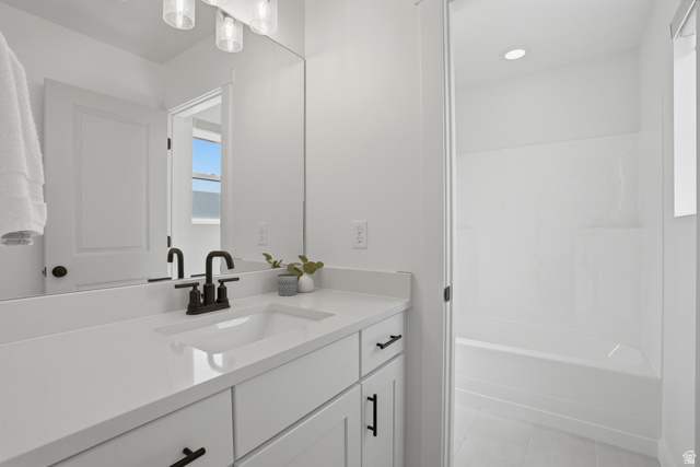 11531 Engelmann Drive Draper, UT 84020 - Photo 24 of 31 Bathroom featuring a single vanity with an integrated sink, white countertop, and dark-finished faucet