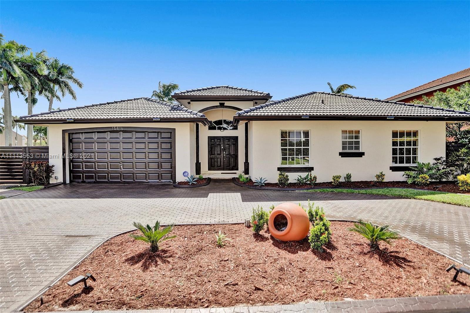 15816 Southwest 103rd Lane Miami, FL 33196 - Photo 2 of 49 a front view of a house with patio