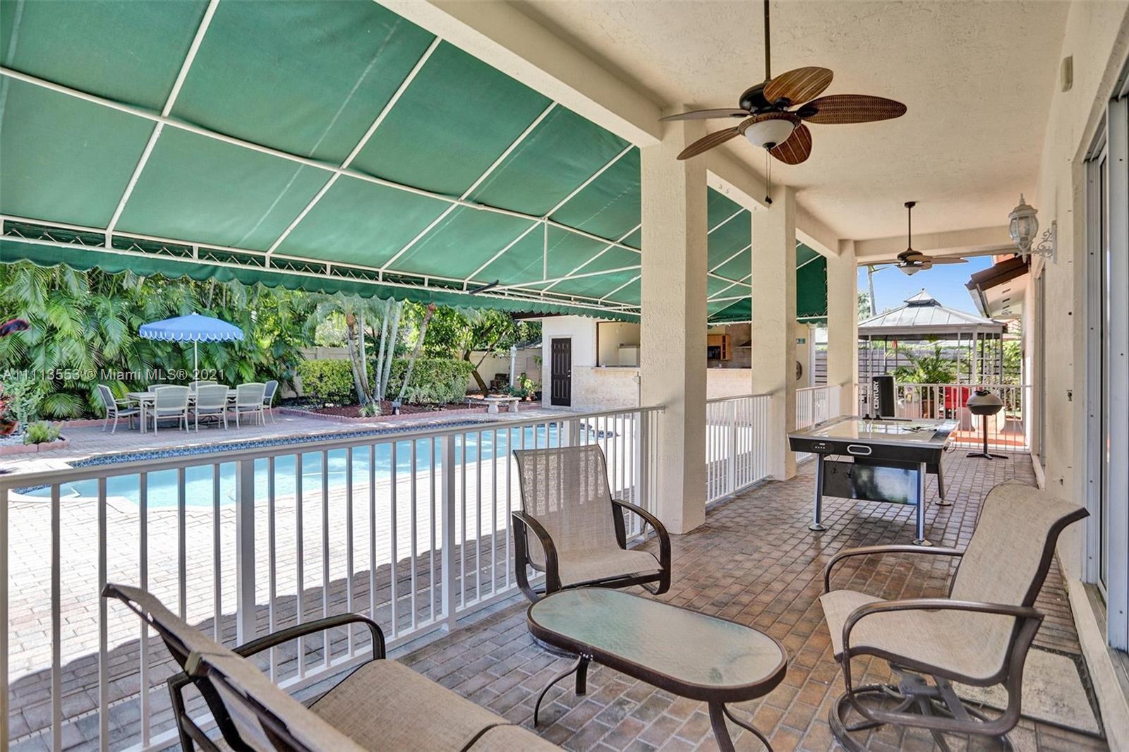15816 Southwest 103rd Lane Miami, FL 33196 - Photo 15 of 49 a balcony with table and chairs