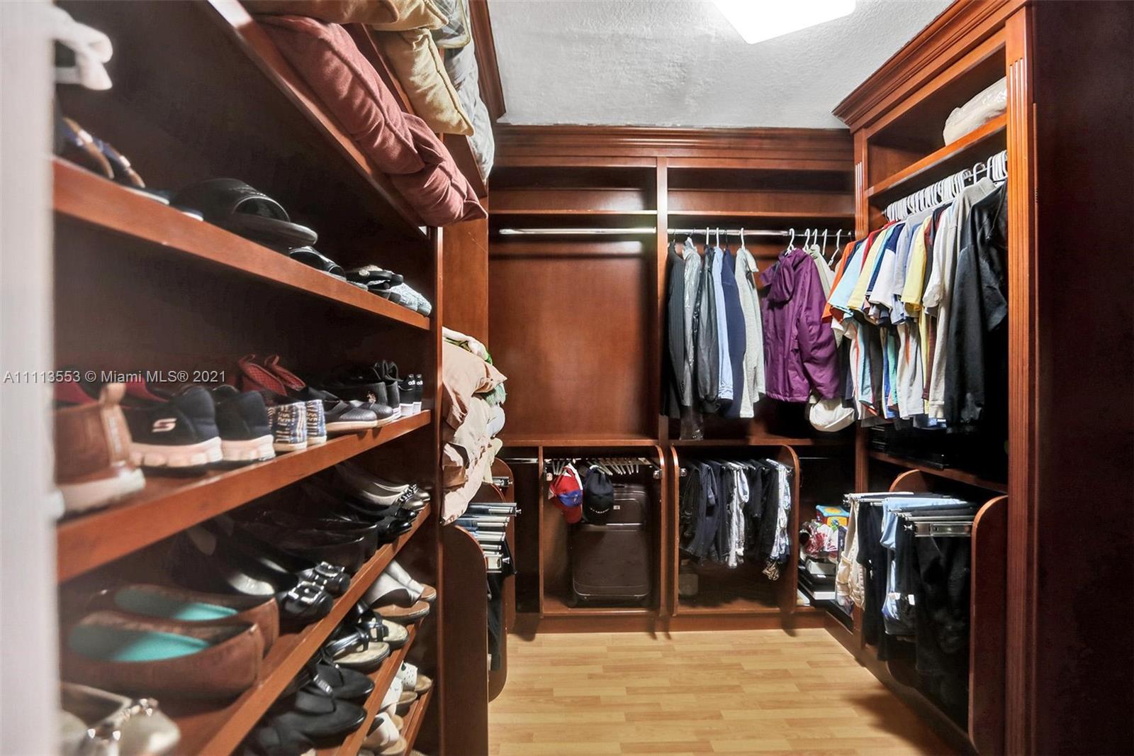15816 Southwest 103rd Lane Miami, FL 33196 - Photo 18 of 49 a view of walk in closet with clothes and shoes