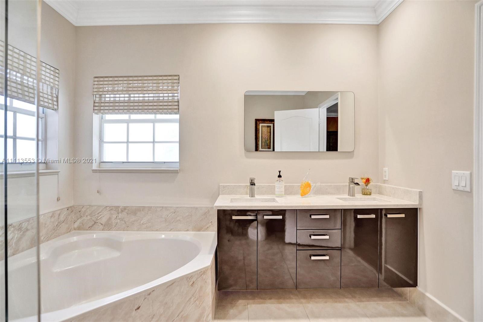 15816 Southwest 103rd Lane Miami, FL 33196 - Photo 21 of 49 a bathroom with a tub sink and mirror