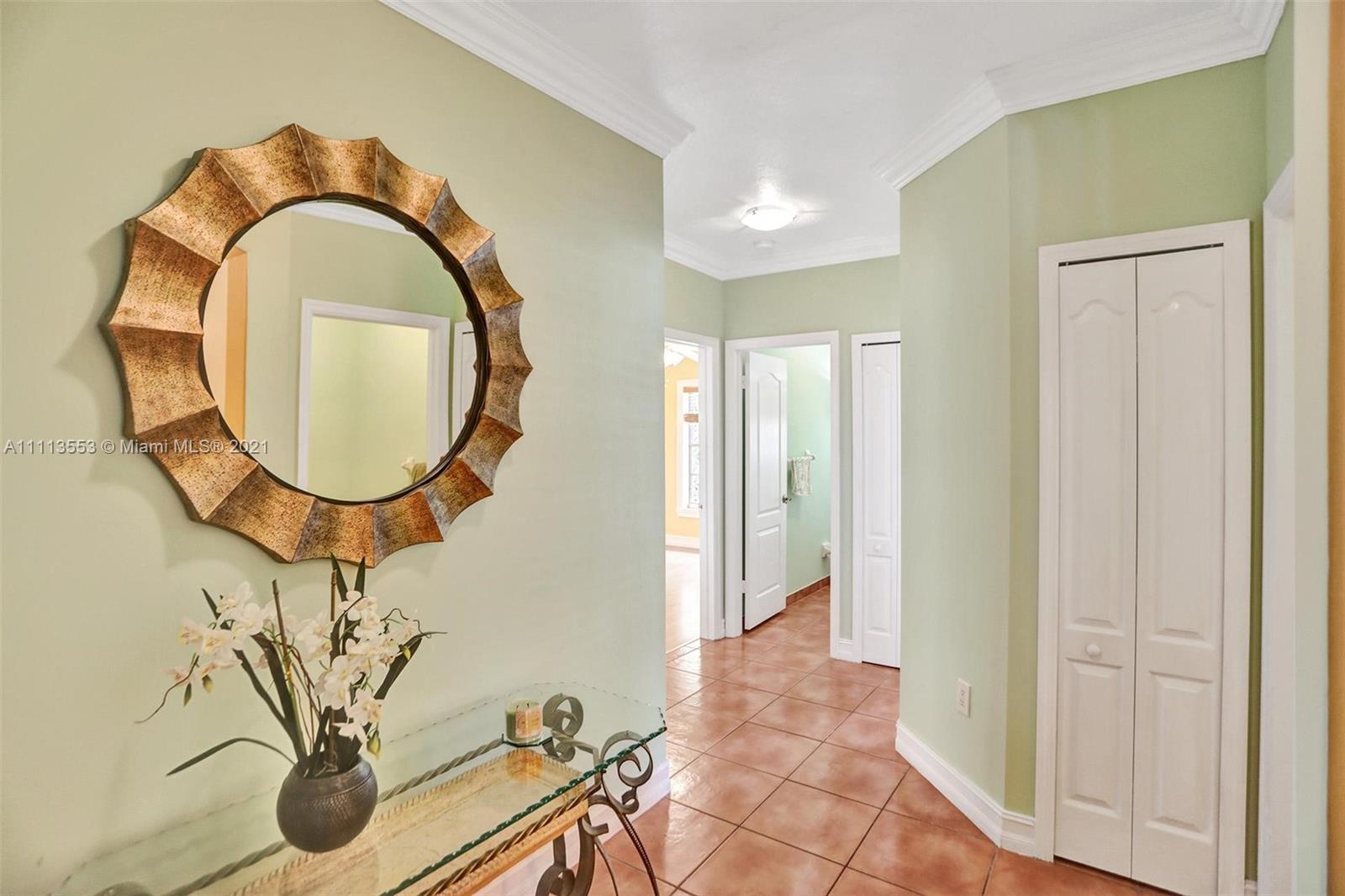 15816 Southwest 103rd Lane Miami, FL 33196 - Photo 22 of 49 a view of a livingroom with furniture and a mirror