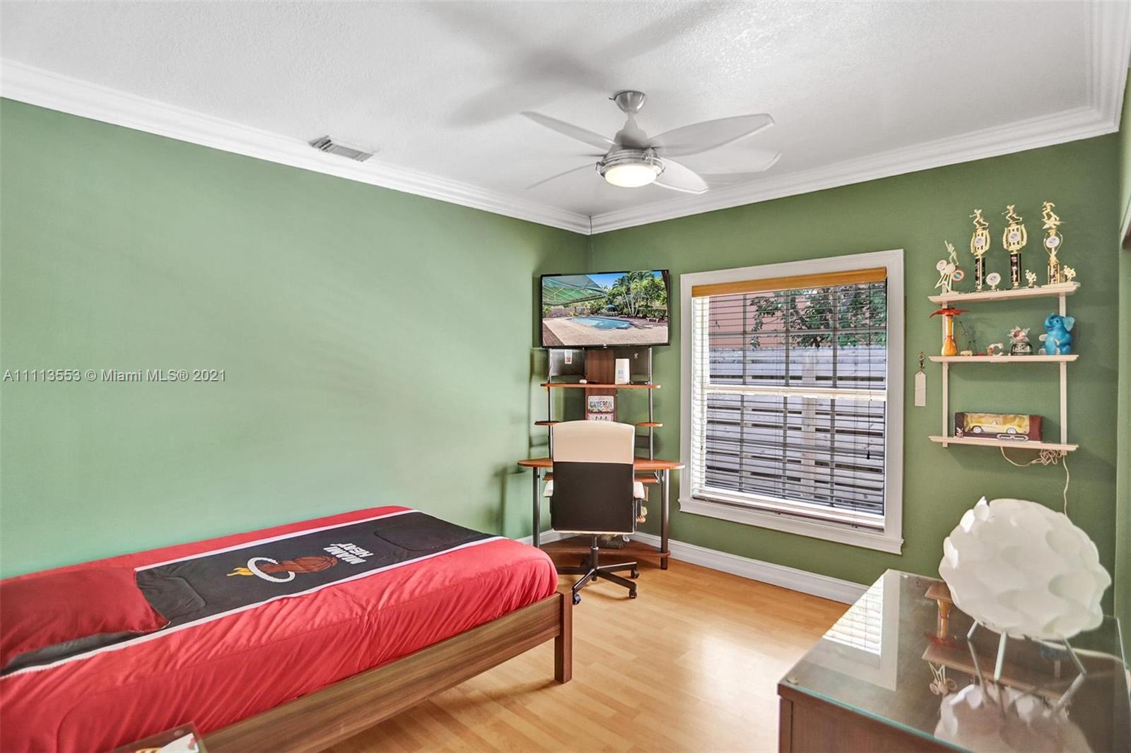 15816 Southwest 103rd Lane Miami, FL 33196 - Photo 23 of 49 a bedroom with a bed and a chandelier