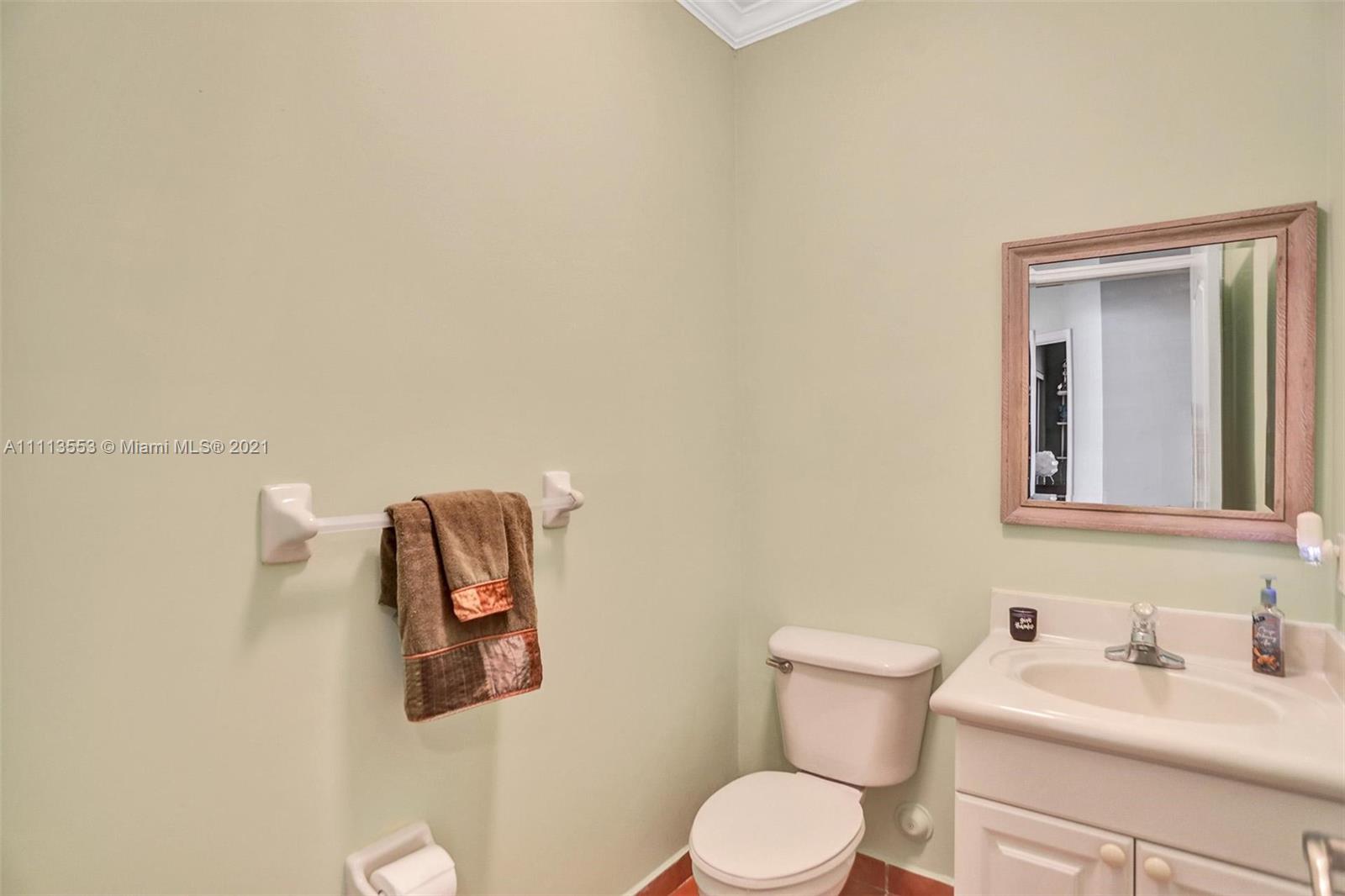15816 Southwest 103rd Lane Miami, FL 33196 - Photo 26 of 49 a bathroom with a toilet sink vanity and mirror
