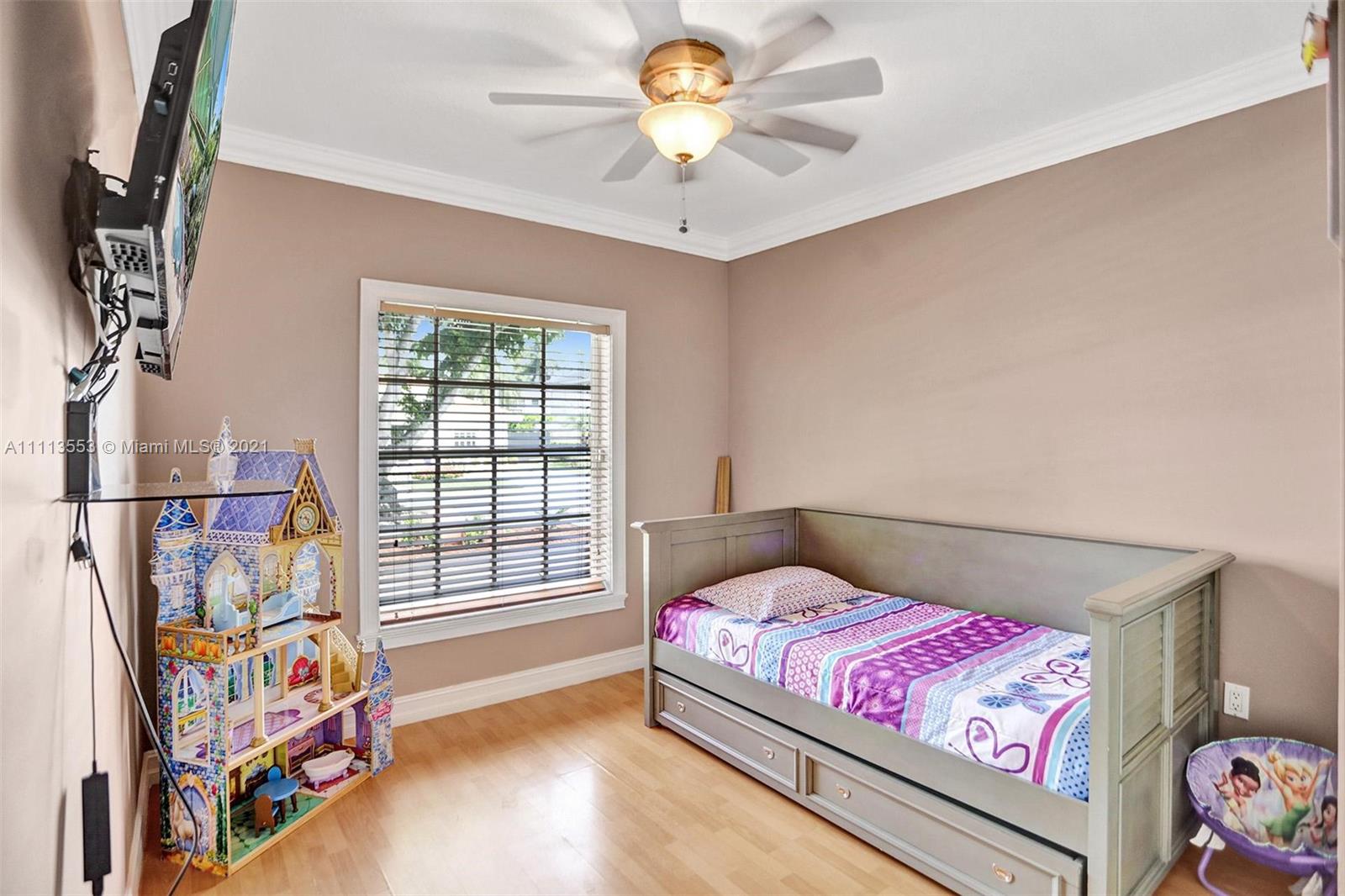 15816 Southwest 103rd Lane Miami, FL 33196 - Photo 27 of 49 a bedroom with a bed and a chandelier