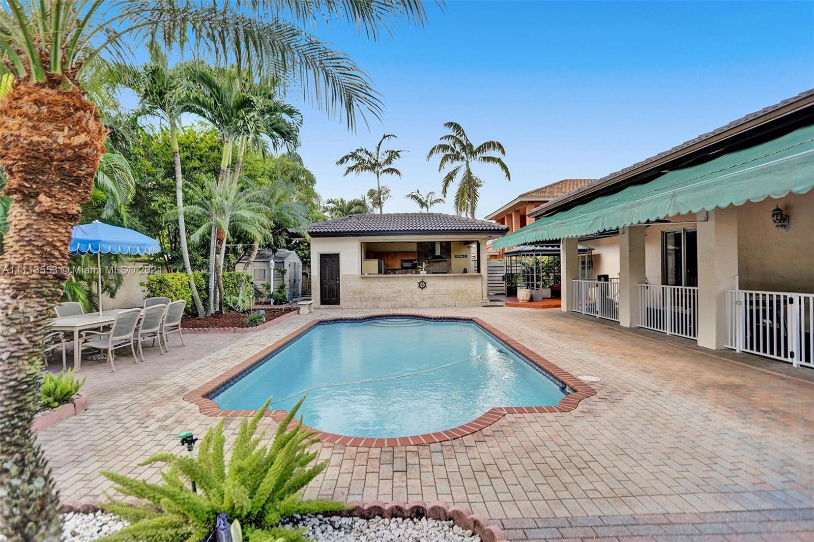 15816 Southwest 103rd Lane Miami, FL 33196 - Photo 30 of 49 a view of a house with a swimming pool and sitting area