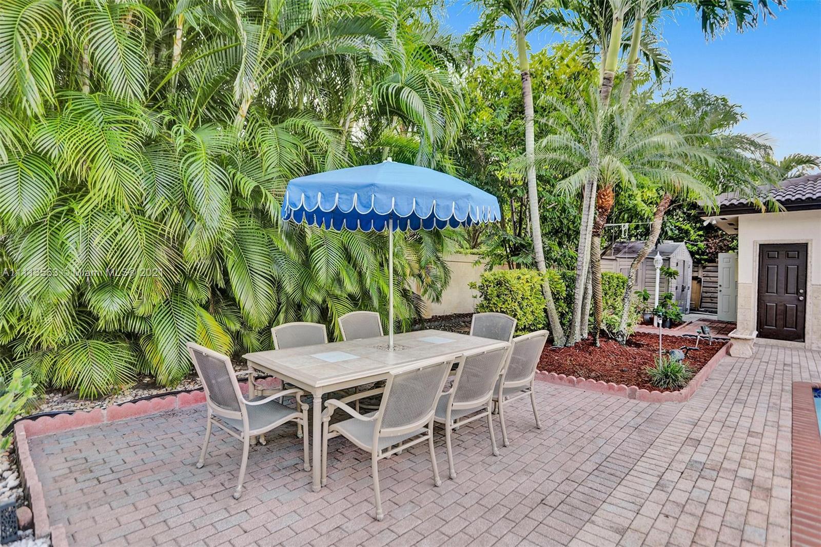15816 Southwest 103rd Lane Miami, FL 33196 - Photo 32 of 49 a patio with a patio table and chairs