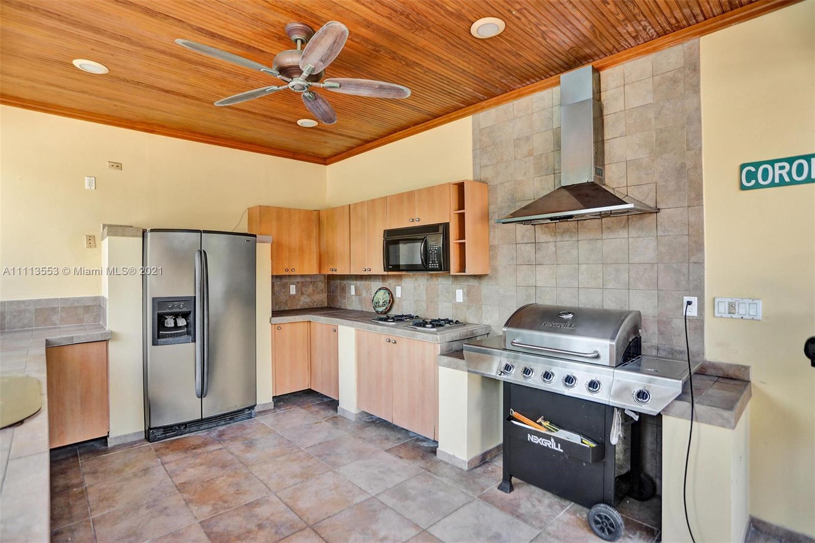 15816 Southwest 103rd Lane Miami, FL 33196 - Photo 38 of 49 a kitchen with stainless steel appliances granite countertop a stove refrigerator and microwave