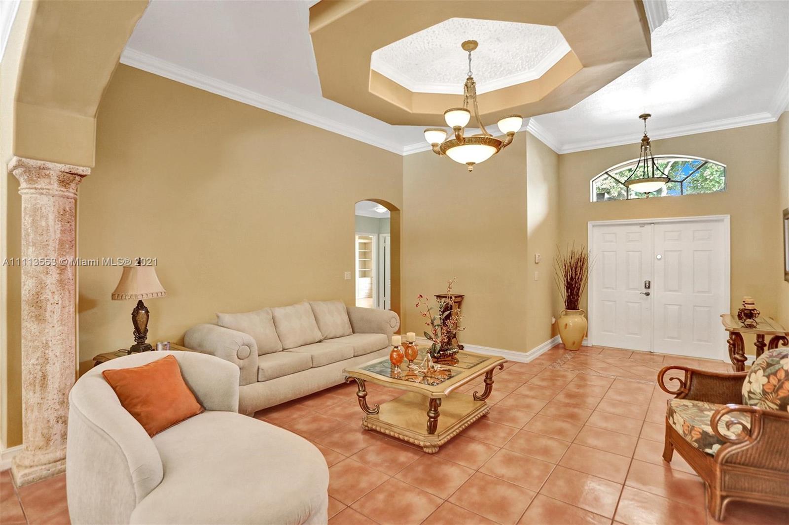 15816 Southwest 103rd Lane Miami, FL 33196 - Photo 5 of 49 a living room with furniture a chandelier and a chandelier