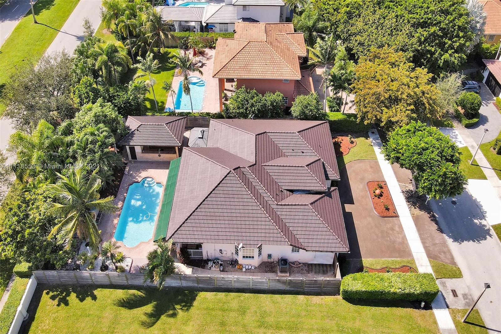 15816 Southwest 103rd Lane Miami, FL 33196 - Photo 46 of 49 an aerial view of a house with swimming pool and garden