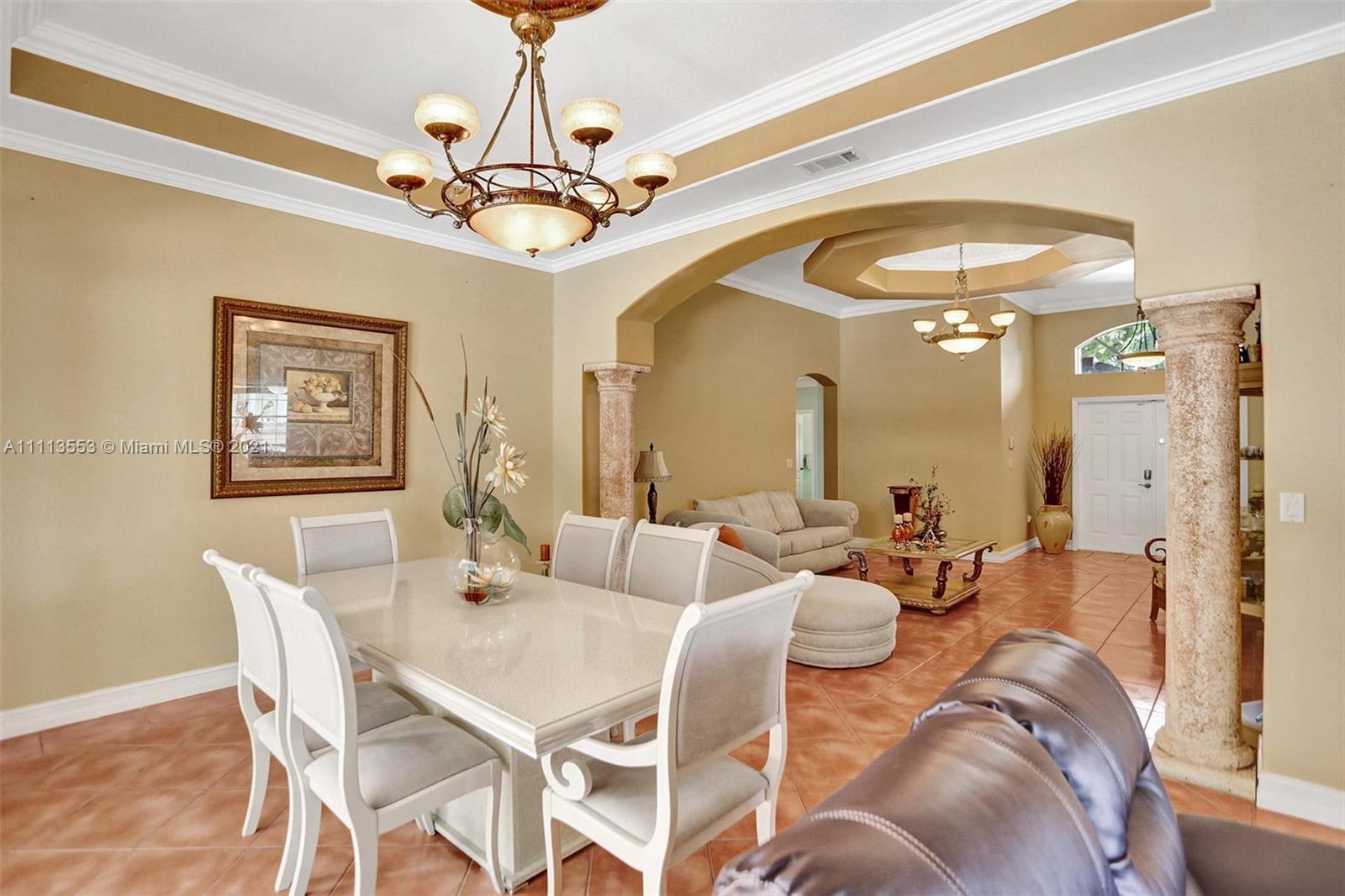 15816 Southwest 103rd Lane Miami, FL 33196 - Photo 6 of 49 a view of a dining room with furniture and a chandelier