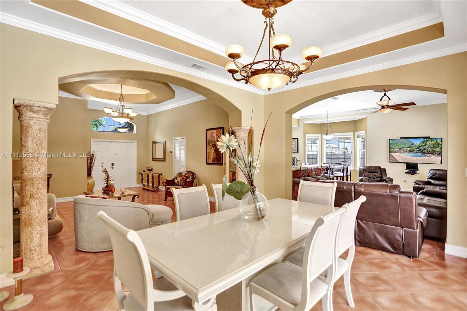15816 Southwest 103rd Lane Miami, FL 33196 - Photo 7 of 49 a view of a dining room with furniture and a chandelier