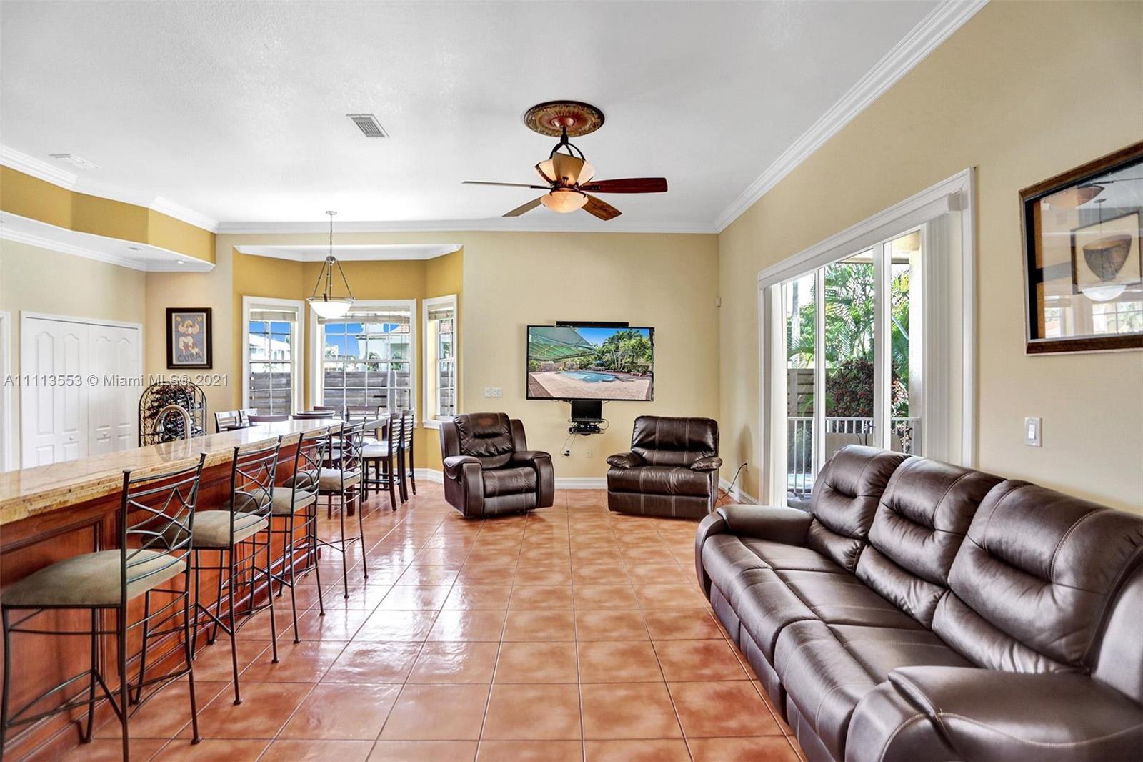 15816 Southwest 103rd Lane Miami, FL 33196 - Photo 9 of 49 a living room with fireplace furniture and a large window