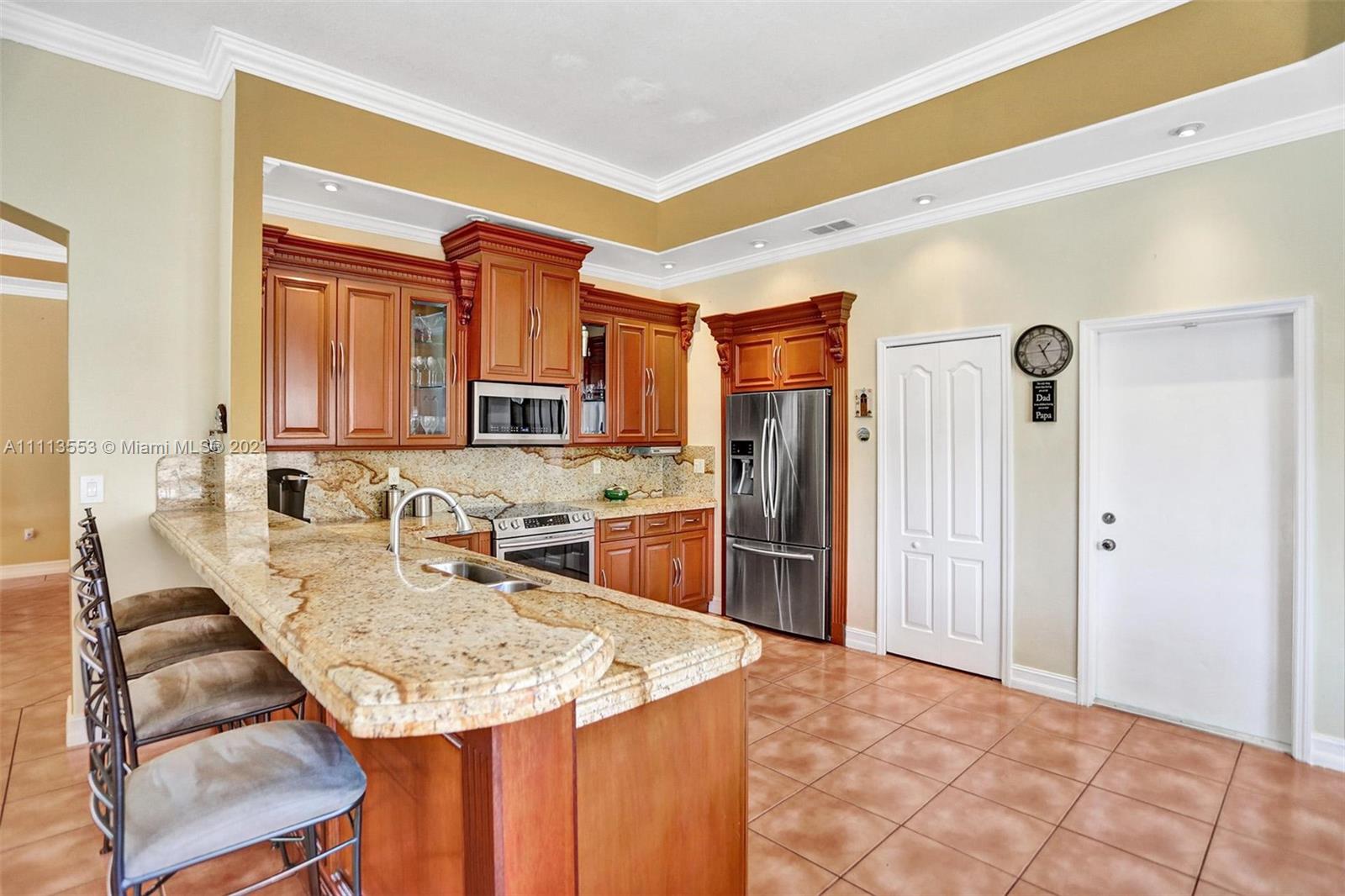 15816 Southwest 103rd Lane Miami, FL 33196 - Photo 10 of 49 a kitchen with stainless steel appliances granite countertop a sink and cabinets
