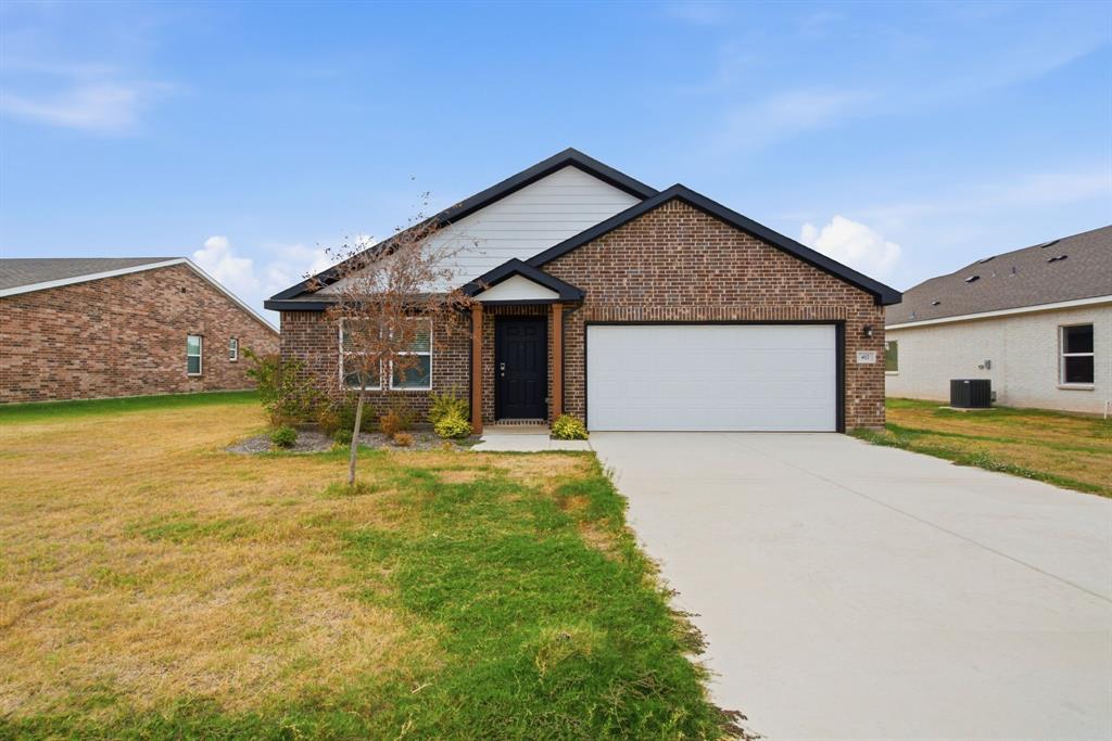 417 Jameson Springtown, TX 76082 - Photo 1 of 25 Brick and siding exterior, front-facing garage with a white door, concrete driveway, and covered front entry