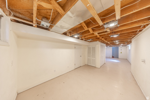193 Locust Street Clearfield, UT 84015 - Photo 19 of 29 Expansive unfinished basement featuring exposed ceiling joists, recessed lighting, painted concrete flooring, and white painted walls