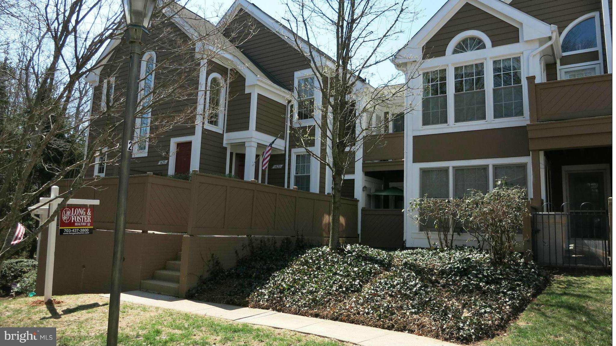 1423 Church Hill Place, Unit 1423 Reston, VA 20194 - Photo 2 of 26 a front view of a multi story residential apartment building
