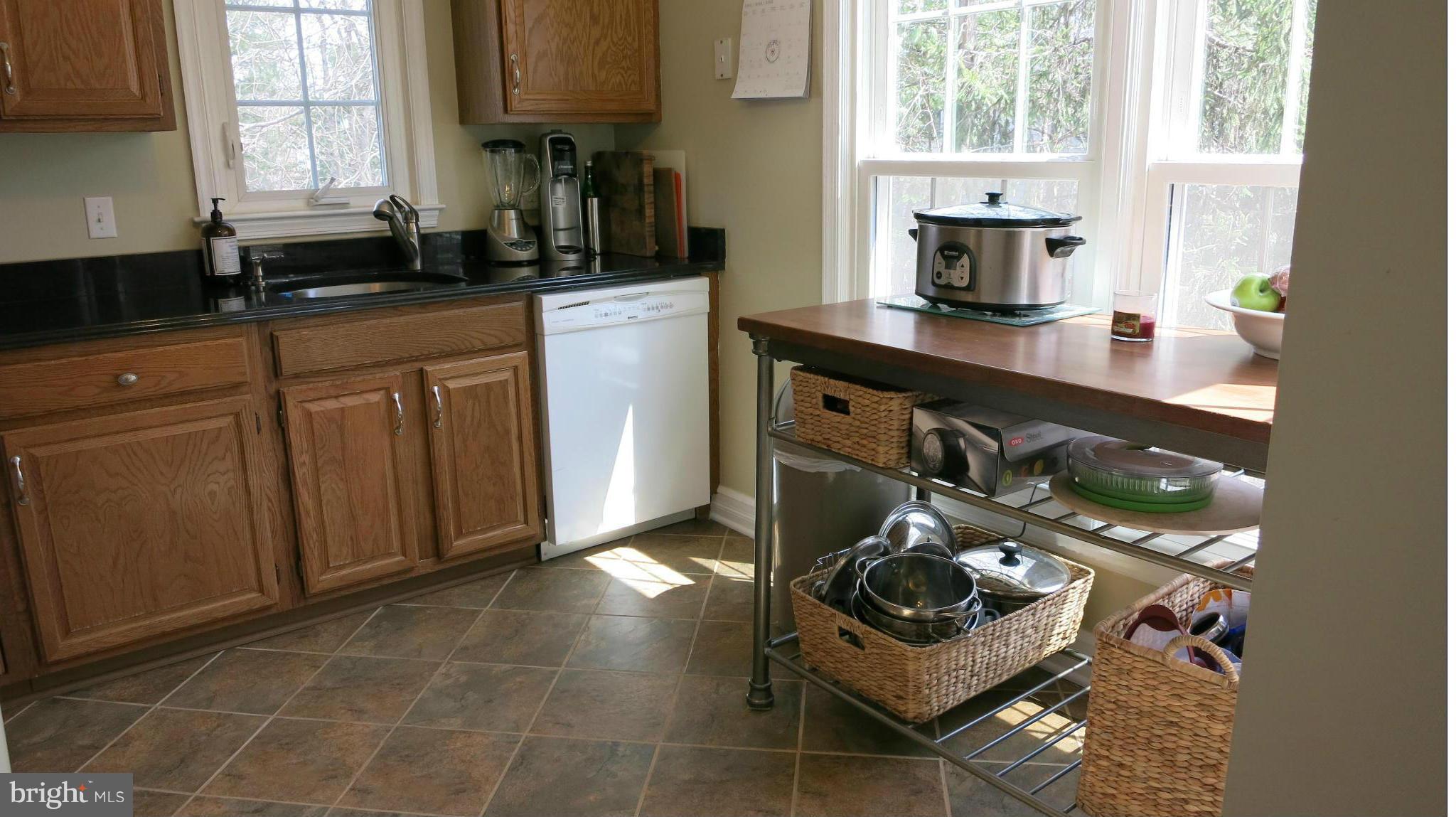 1423 Church Hill Place, Unit 1423 Reston, VA 20194 - Photo 13 of 26 a kitchen with stainless steel appliances a sink stove and cabinets