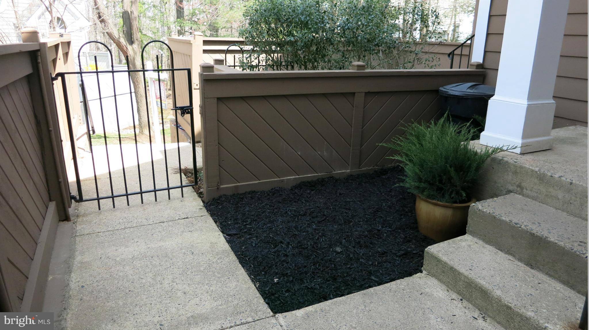 1423 Church Hill Place, Unit 1423 Reston, VA 20194 - Photo 21 of 26 a potted plant sitting in front of a building