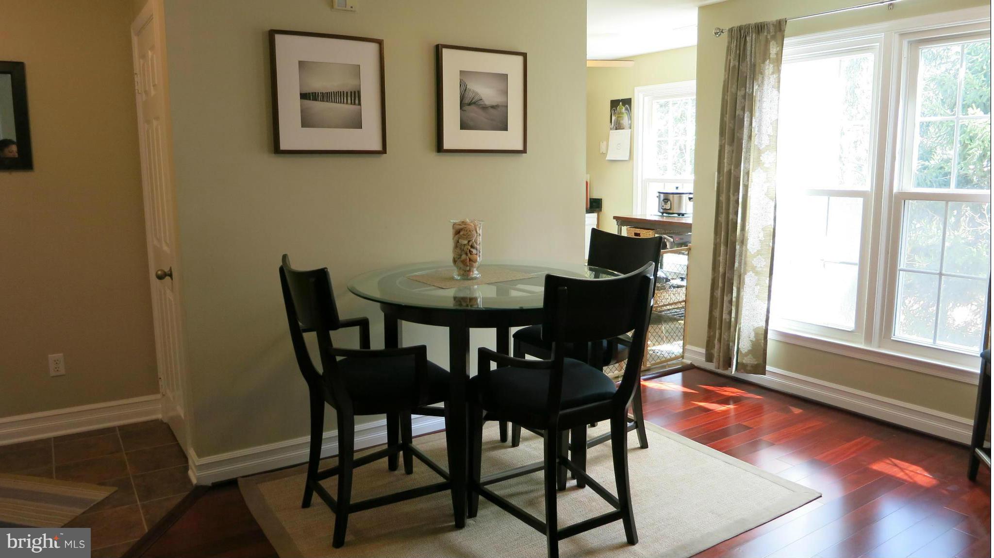 1423 Church Hill Place, Unit 1423 Reston, VA 20194 - Photo 5 of 26 a view of a dining room with furniture and wooden floor