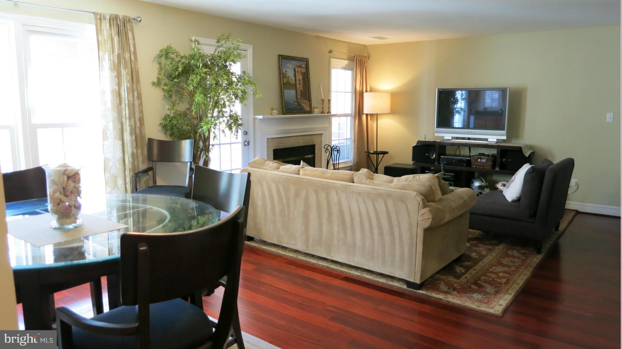 1423 Church Hill Place, Unit 1423 Reston, VA 20194 - Photo 6 of 26 a living room with furniture and a fireplace