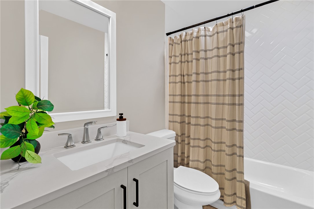 7989 143rd Street Sebastian, FL 32958 - Photo 18 of 30 a bathroom with a sink a toilet and shower