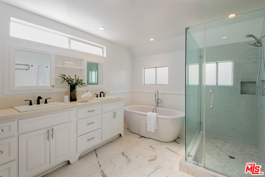 543 North June Street Los Angeles, CA 90004 - Photo 8 of 10 a spacious bathroom with double vanity a mirror a shower and vanity