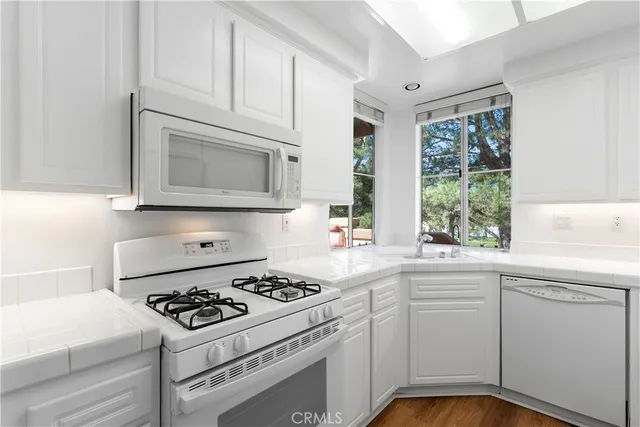 a kitchen with a stove a sink and a microwave