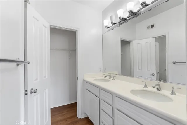 a bathroom with a double vanity sink mirror and vanity