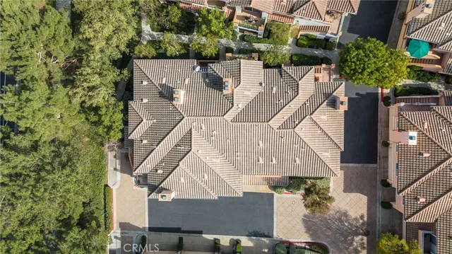 an aerial view of a house with a yard and potted plants