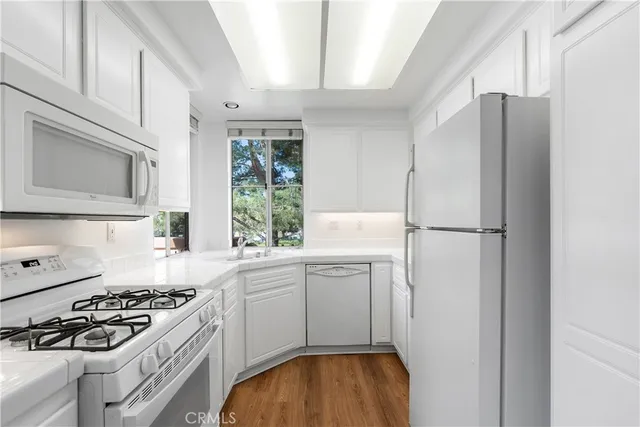 a kitchen with a sink stove and refrigerator