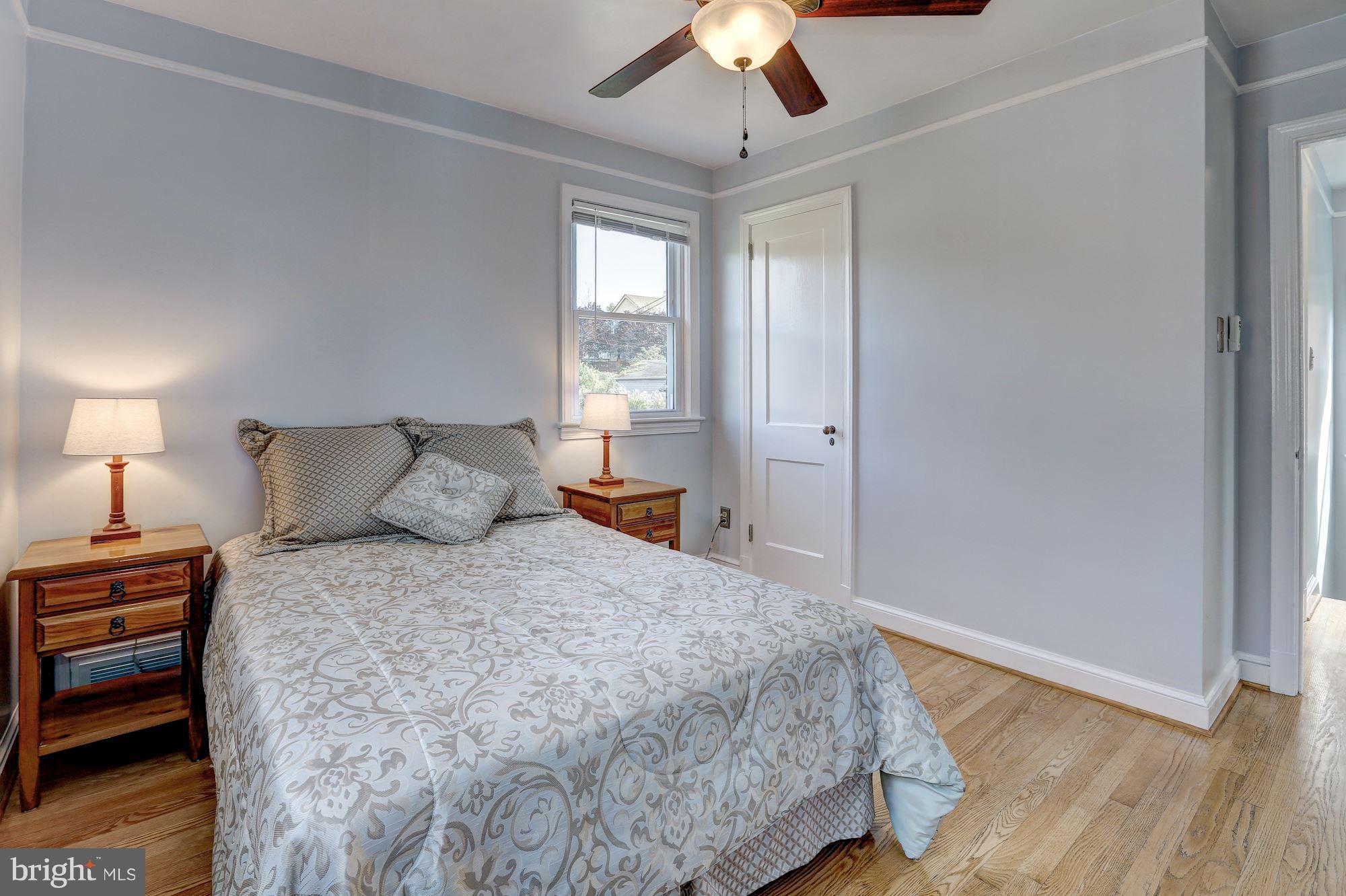 6513 3rd Street Northwest Washington, DC 20012 - Photo 13 of 30 a bedroom with a bed and a chandelier