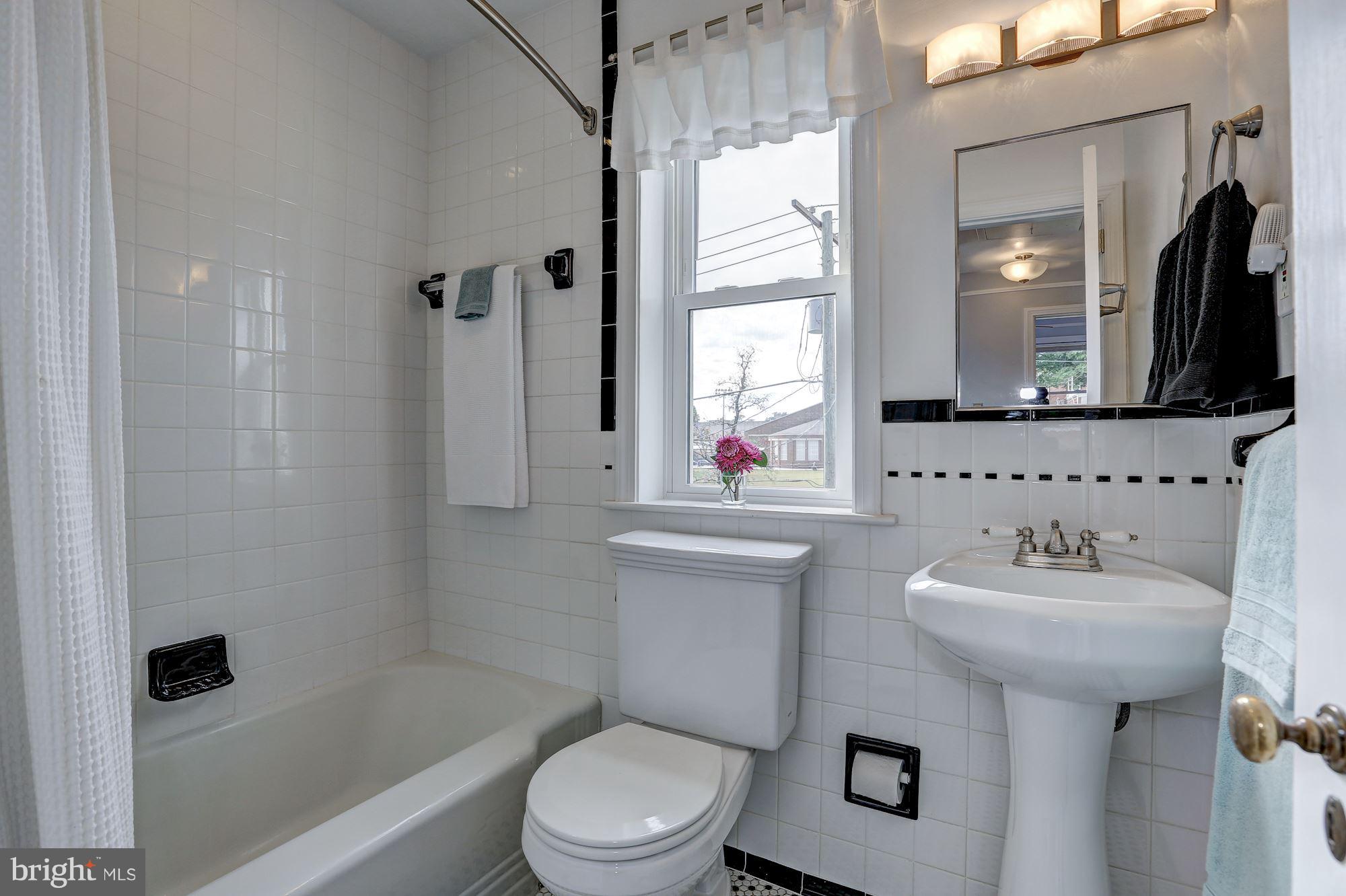 6513 3rd Street Northwest Washington, DC 20012 - Photo 17 of 30 a bathroom with a toilet sink and mirror