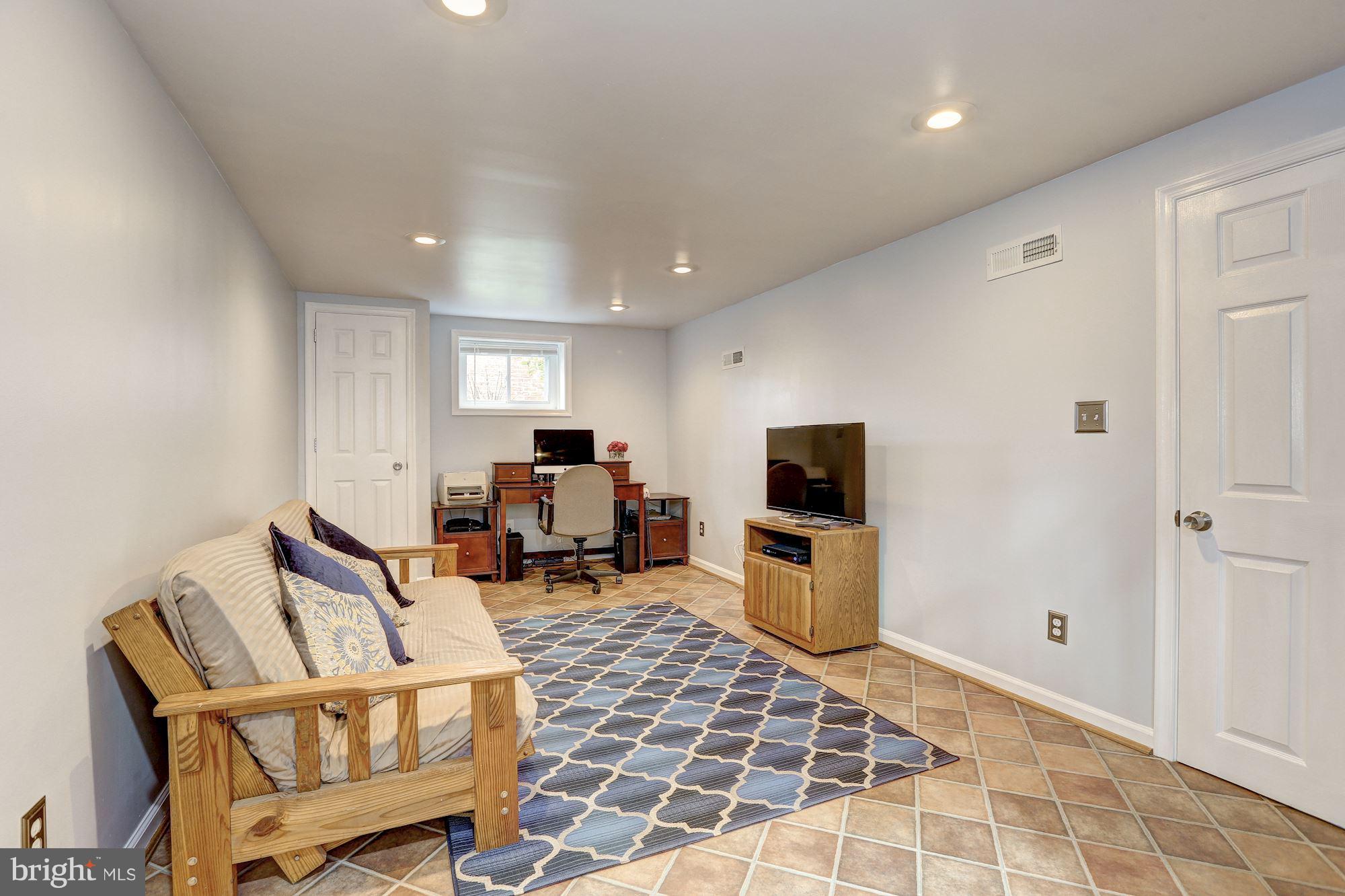 6513 3rd Street Northwest Washington, DC 20012 - Photo 18 of 30 a living room with furniture and a flat screen tv