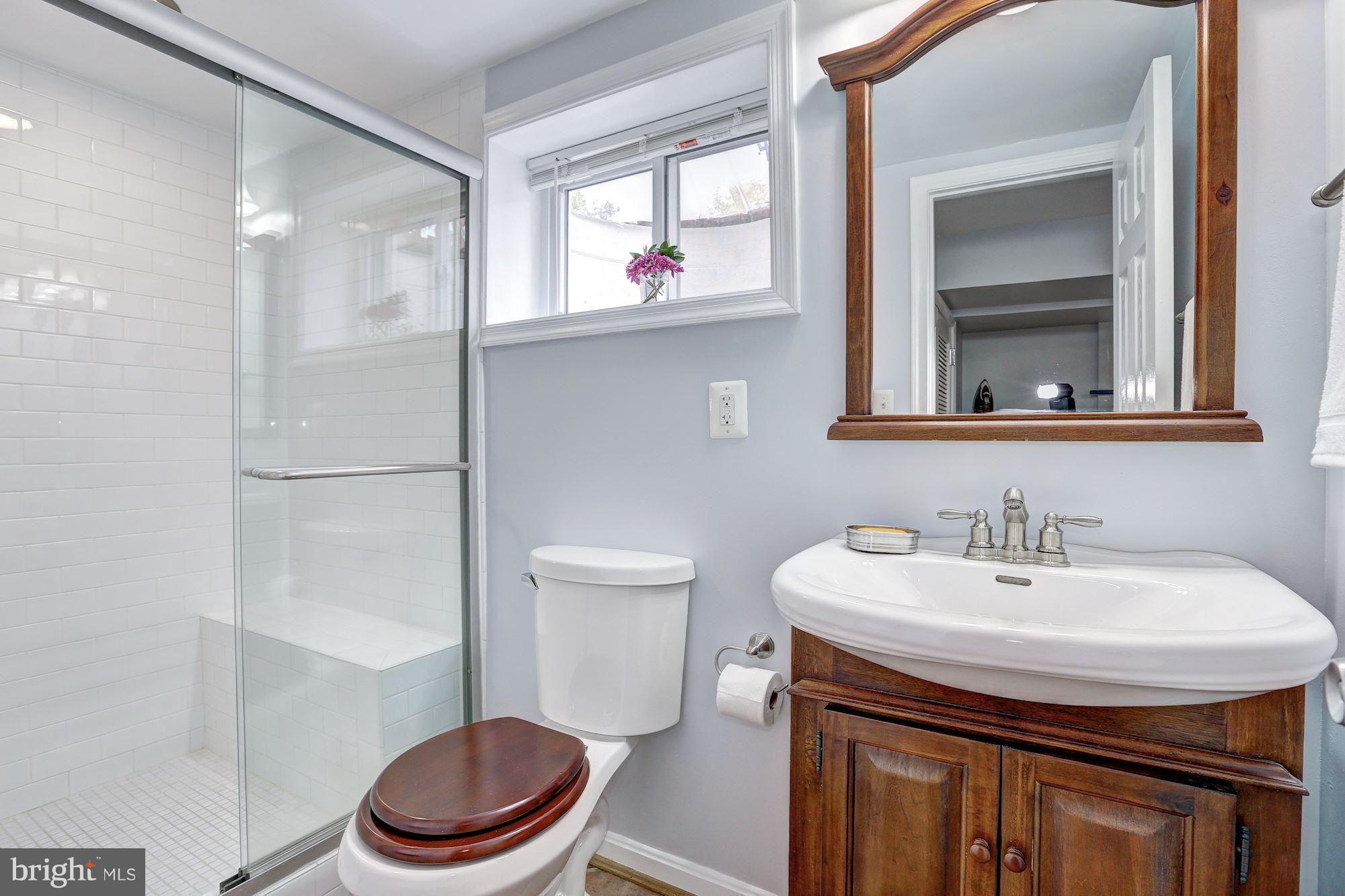 6513 3rd Street Northwest Washington, DC 20012 - Photo 20 of 30 a bathroom with a sink a toilet and a mirror