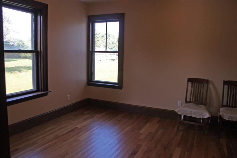 41 Depot Road Cataumet, MA 02534 - Photo 13 of 34 an empty room with wooden floor and windows