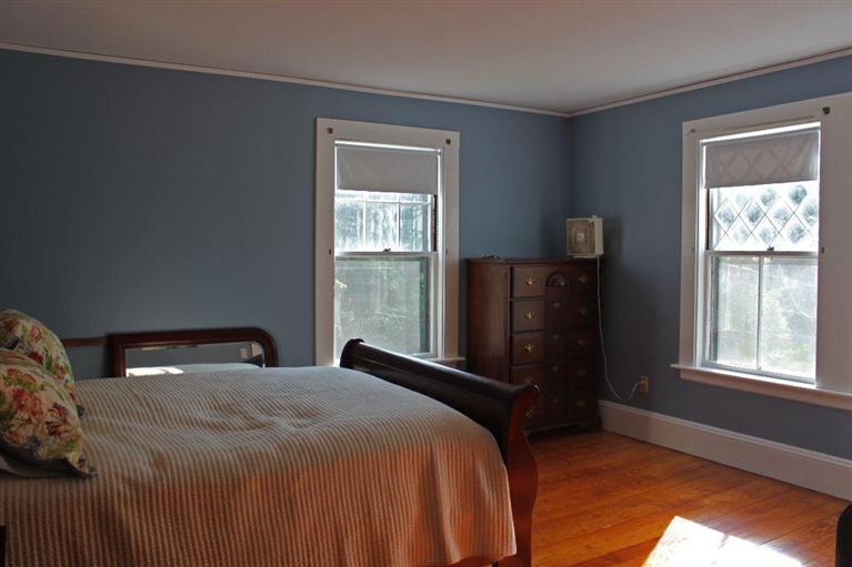 41 Depot Road Cataumet, MA 02534 - Photo 19 of 34 a bedroom with a bed and wooden floor