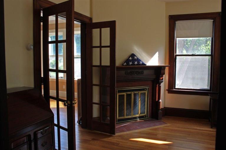 41 Depot Road Cataumet, MA 02534 - Photo 3 of 34 a living room with wooden floor and a fireplace