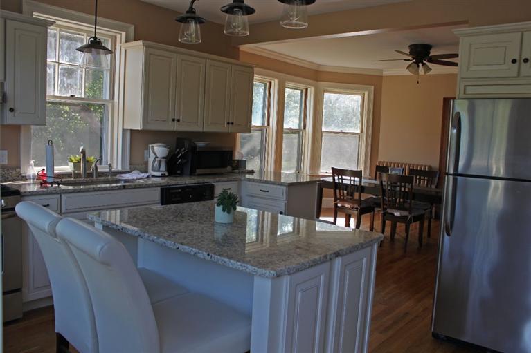 41 Depot Road Cataumet, MA 02534 - Photo 10 of 34 a kitchen with granite countertop a table chairs microwave and cabinets