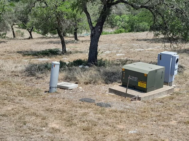 a view of a yard with wooden fence