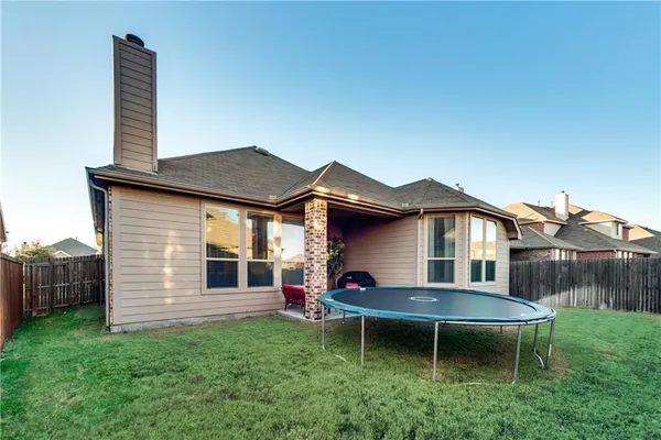 a view of a house with a yard and sitting area