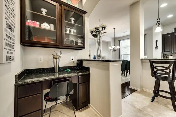 a kitchen with a table chairs refrigerator and microwave