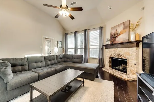 a living room with furniture a flat screen tv and a fireplace