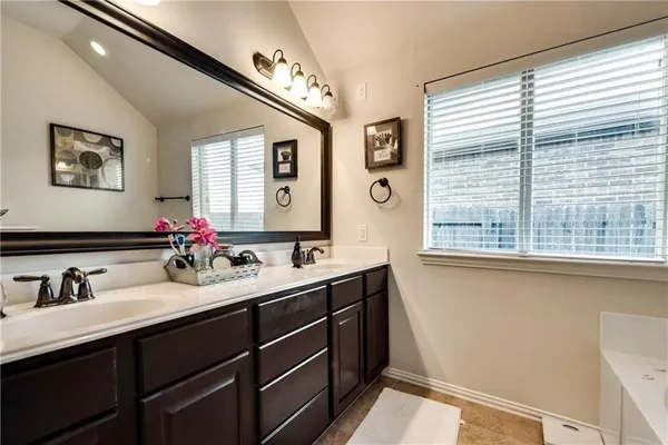 a bathroom with a double vanity sink and a mirror