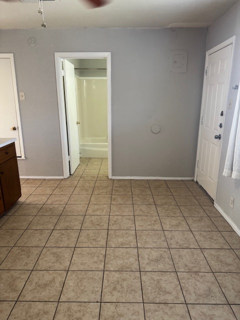 1802 West Avenue H, Unit A Temple, TX 76504 - Photo 6 of 6 Empty room featuring light tile patterned floors and ceiling fan