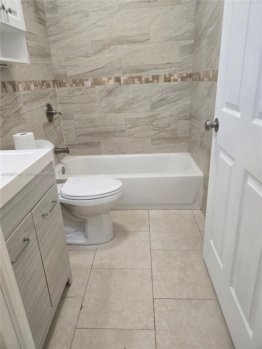 9740 Northwest 5th Avenue Miami, FL 33150 - Photo 14 of 18 a bathroom with a toilet a sink and bathtub