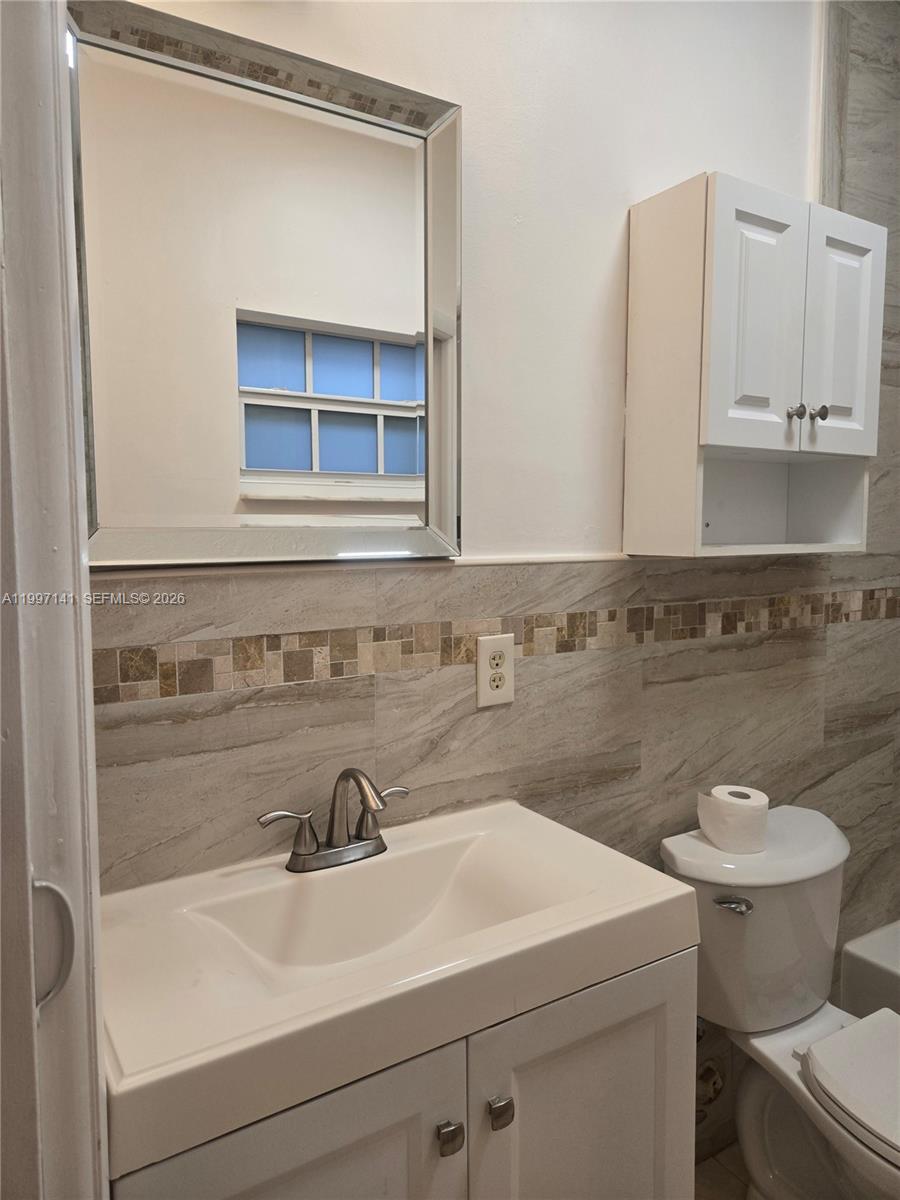 9740 Northwest 5th Avenue Miami, FL 33150 - Photo 16 of 18 a bathroom with a sink and a toilet